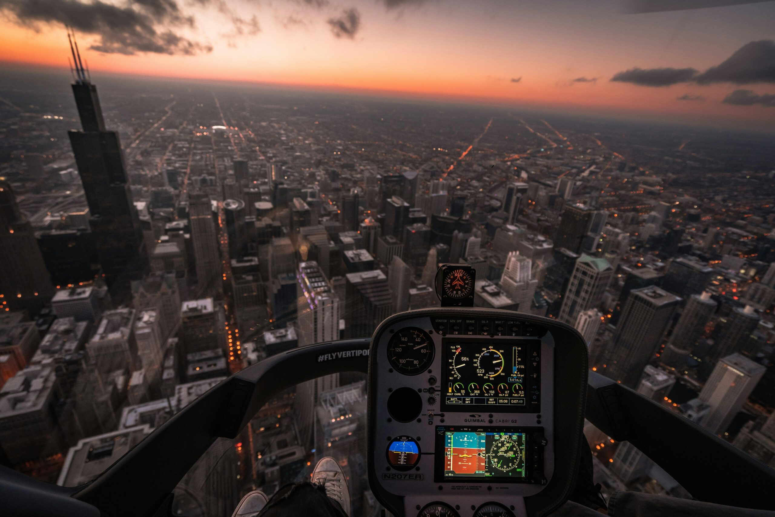 A mesmerizing aerial view of Chicago's skyline at dusk from a helicopter cockpit.